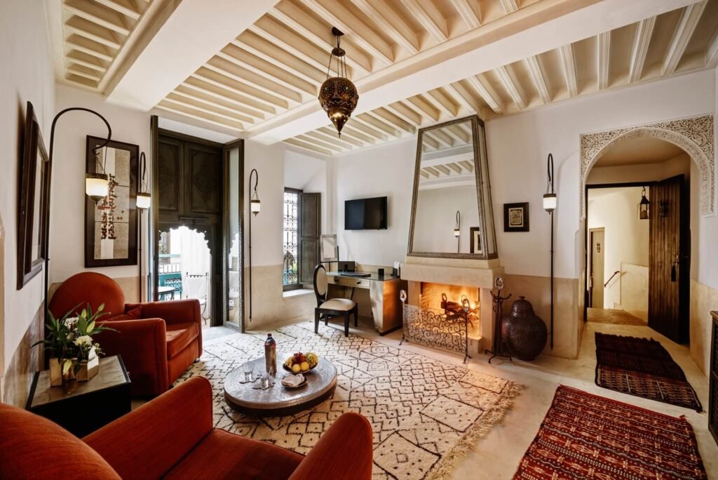Luxury suite at Riad Farnatchi with fireplace, elegant furnishings, and warm ambiance