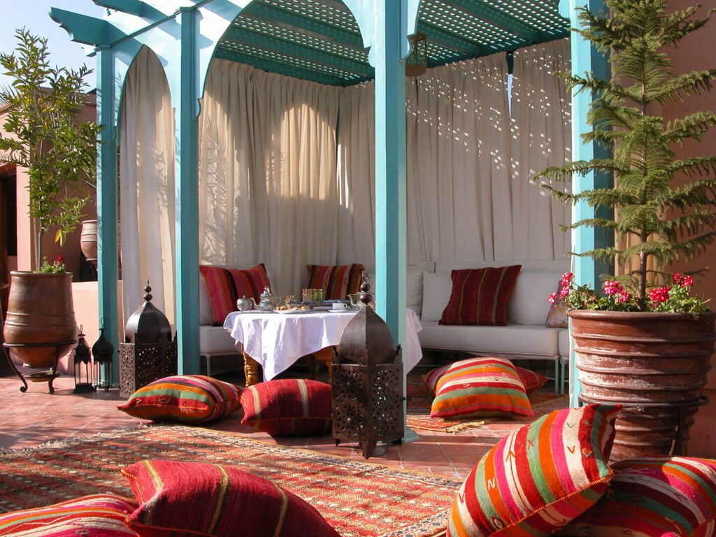 Rooftop terrace at Riad Kniza Marrakech overlooking the Medina at sunset