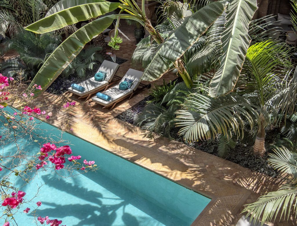 Rooftop terrace pool at La Sultana Marrakech overlooking the Marrakech Medina at sunset