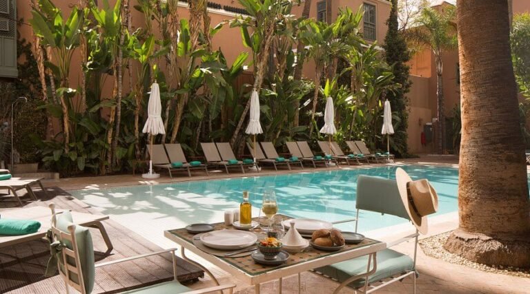 Les Jardins de la Médina Marrakech lush garden with large pool surrounded by palm trees