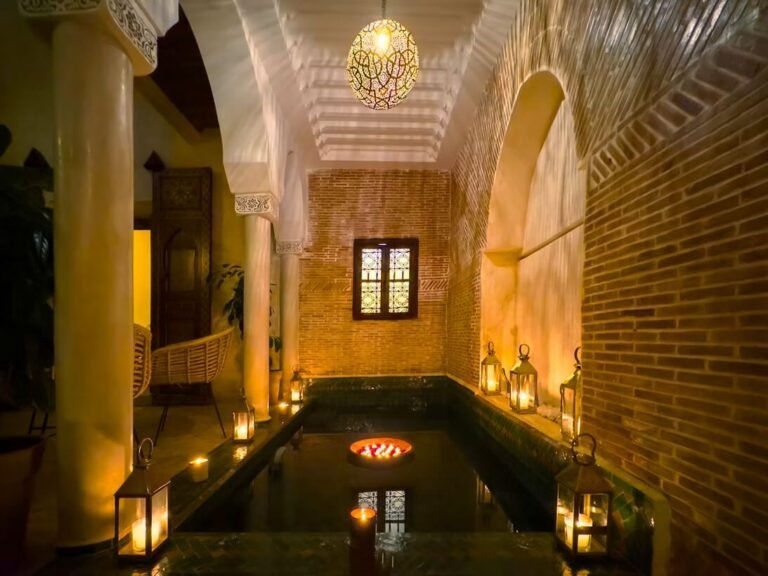Riad Alena courtyard with artistic Moroccan decor, pool, and colorful design elements in Marrakech Medina