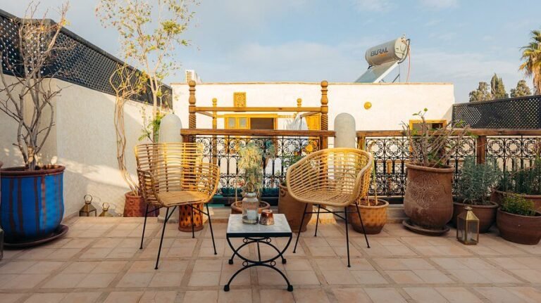 Riad Alena courtyard with artistic Moroccan decor, pool, and colorful design elements in Marrakech Medina