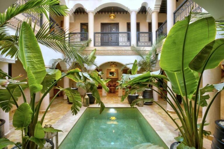 Riad Bijoux courtyard with traditional Moroccan decor, small pool, and cozy seating area in Marrakech Medina