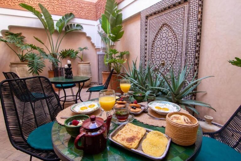 Riad Medina Bloom courtyard with colorful Moroccan decor, rooftop terrace, and cozy seating in Marrakech Medina