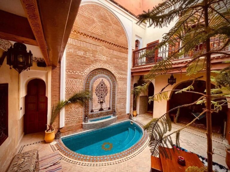 Riad Bonheur du Jour courtyard with traditional Moroccan decor, cozy seating, and a warm ambiance in Marrakech Medina