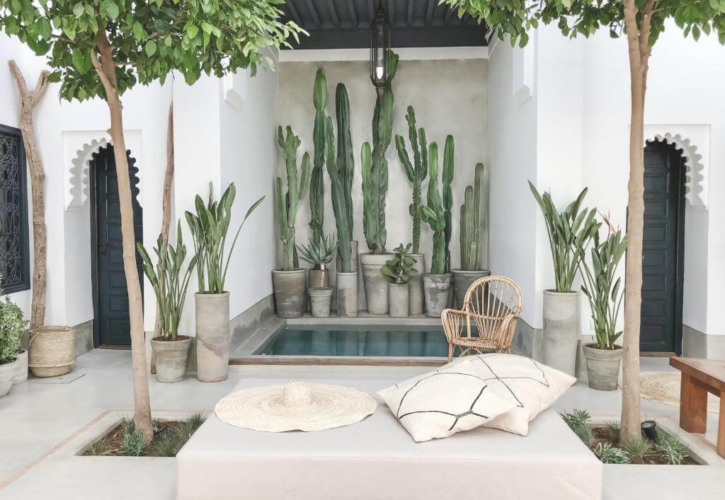 Riad Dar K rooftop terrace with Moroccan decor, cozy seating, and a stunning view of the Medina in Marrakech