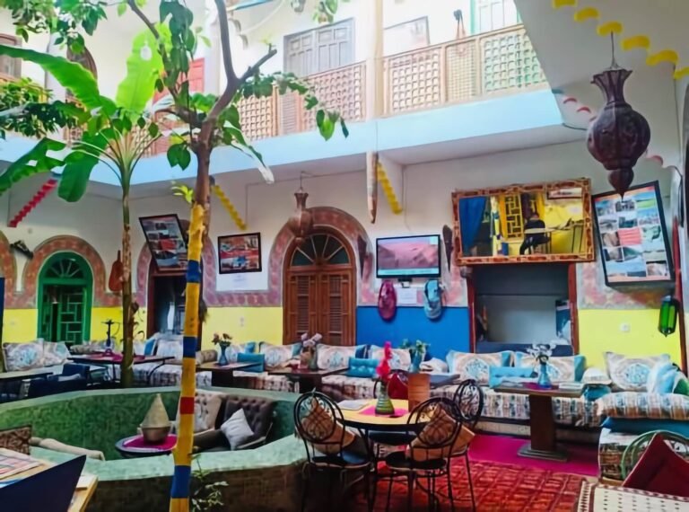 Riad Dia courtyard with colorful Moroccan decor, pool, and social spaces for budget travelers in Marrakech Medina