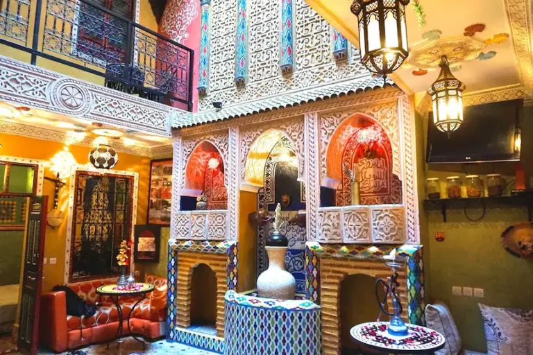 Riad Jennah Rouge courtyard with vibrant Moroccan decor and social spaces for budget travelers in Marrakech Medina
