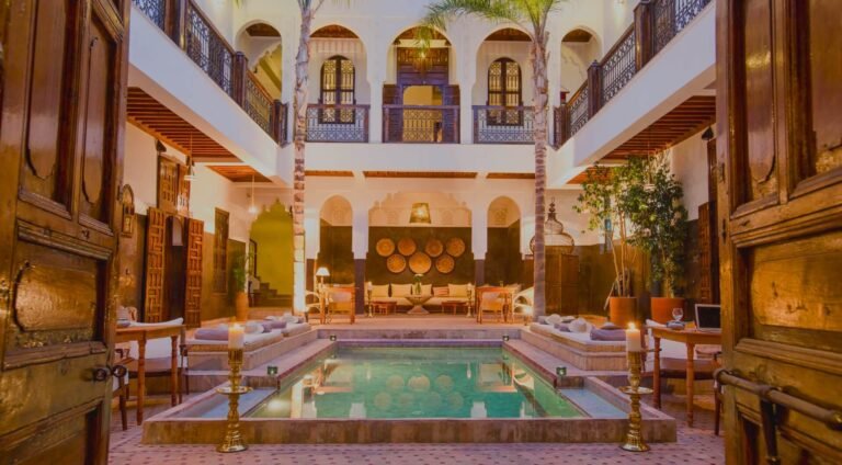 Riad Kasbah courtyard with traditional Moroccan architecture, peaceful garden, and seating area in Marrakech