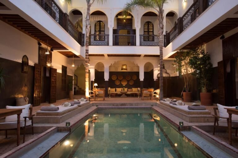 Riad Kasbah courtyard with traditional Moroccan architecture, peaceful garden, and seating area in Marrakech