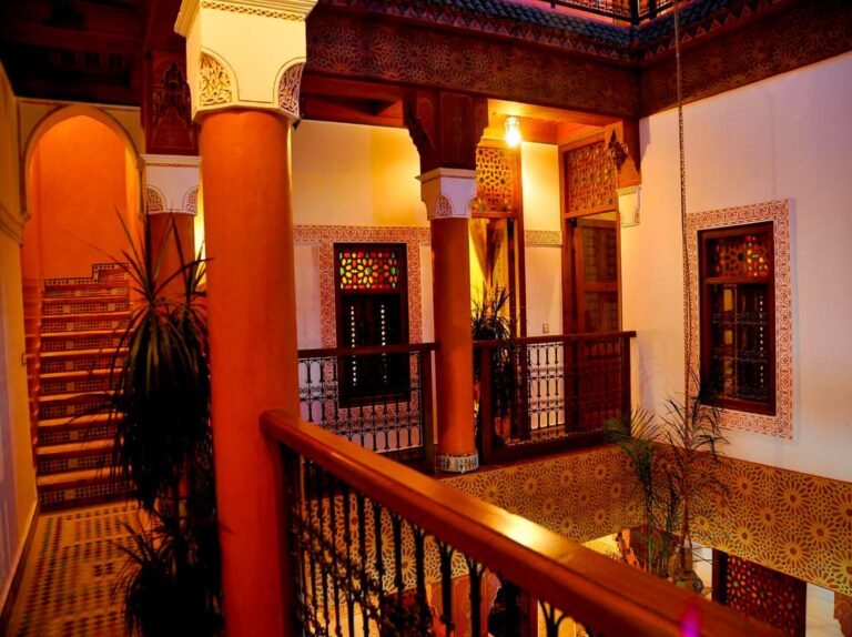 Riad Lila courtyard with traditional Moroccan decor, plants, and a tranquil seating area in Marrakech Medina