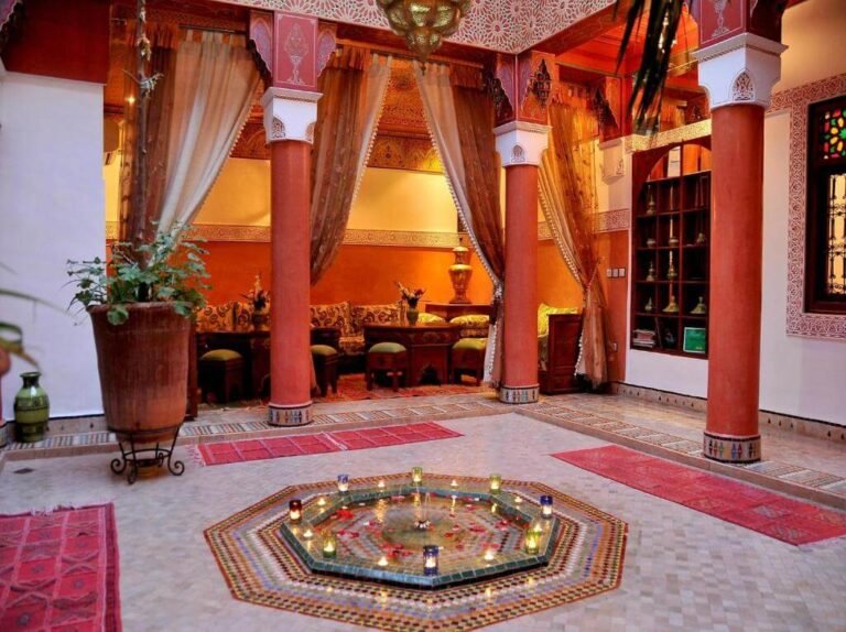 Riad Lila courtyard with traditional Moroccan decor, plants, and a tranquil seating area in Marrakech Medina
