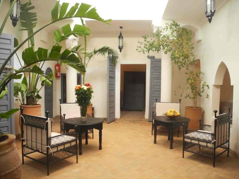 Patio lumineux agrémenté de plantes et d’un espace de détente au Riad Linda à Marrakech.