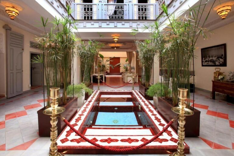 Riad Noos Noos courtyard with traditional Moroccan decor, pool, and rooftop terrace in Marrakech Medina