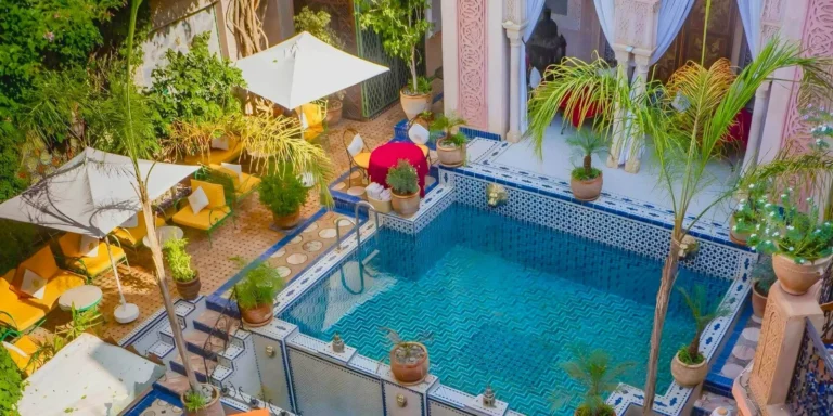 Riad Palais Sebban Marrakech grand courtyard with columns, mosaic tiles and pool