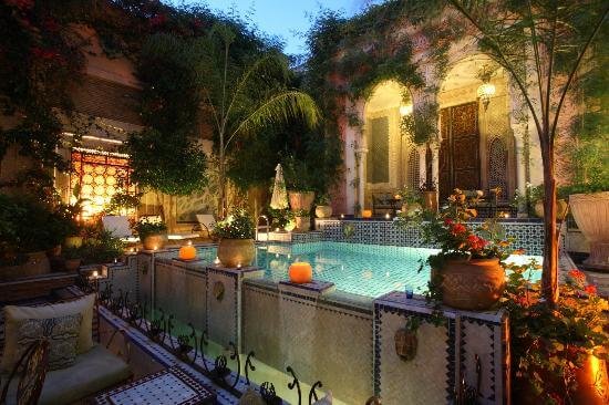 Riad Palais Sebban Marrakech grand courtyard with columns, mosaic tiles and pool