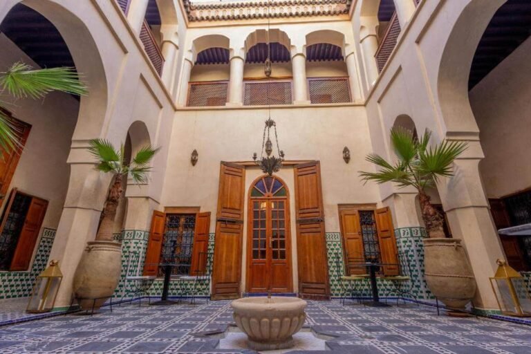 Riad Sarāsvati courtyard with pool, soft Moroccan decor, and peaceful spa ambiance in Marrakech Medina