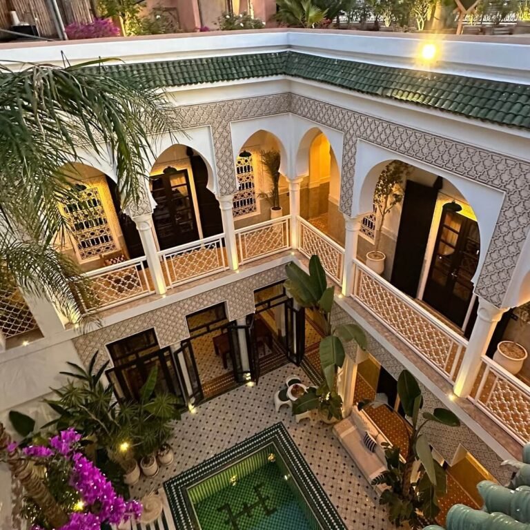 Riad Yasmine Marrakech green tiled courtyard pool surrounded by palm trees