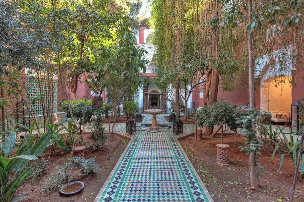 Traditional courtyard at Riad Kaiss with zellige tiles, greenery, and intimate riad atmosphere