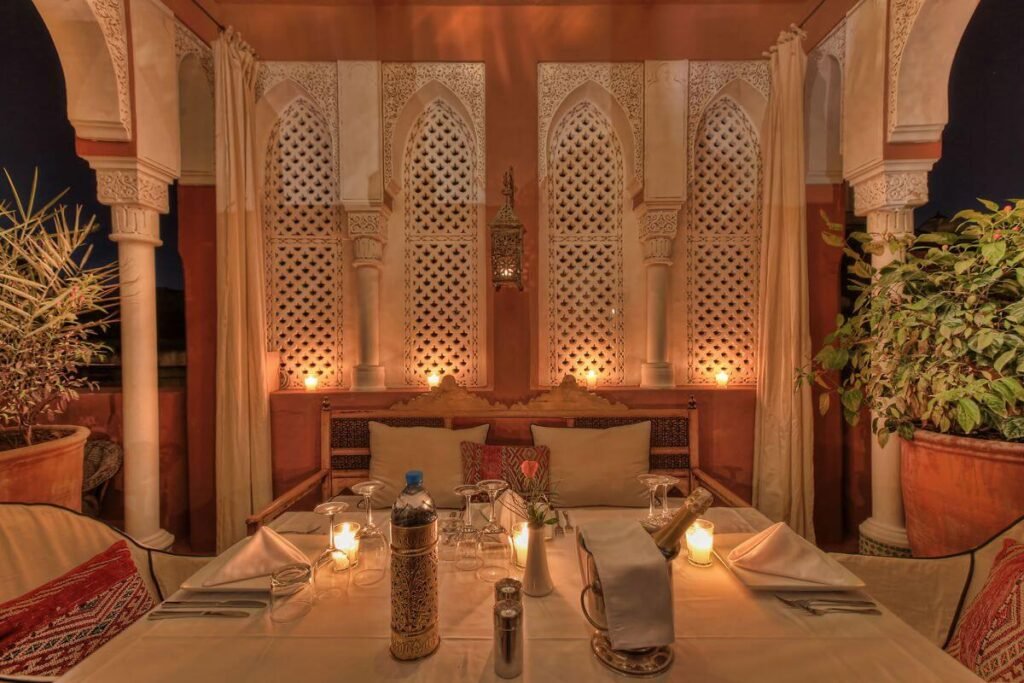 Elegant dining area at Riad Kaiss featuring Moroccan cuisine in a warm, romantic setting