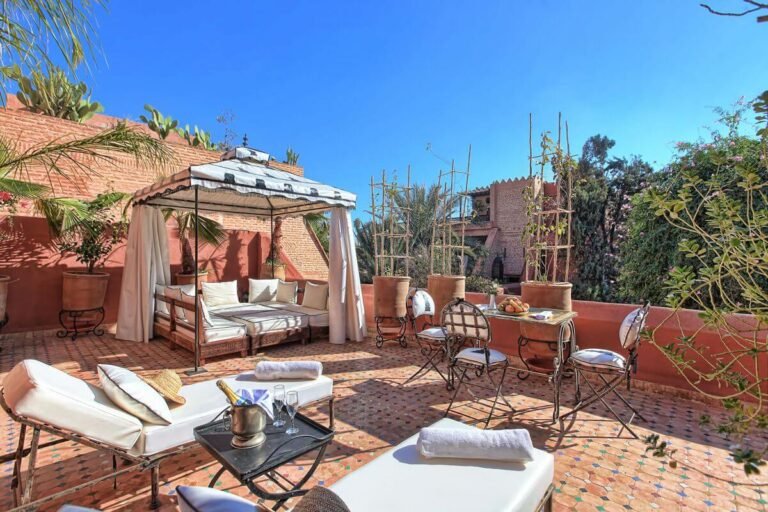 Rooftop terrace at Riad Kaiss with cozy seating and views over the Marrakech Medina