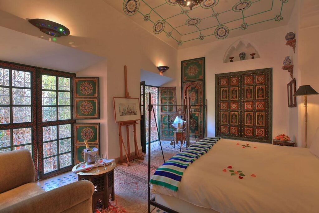 Romantic suite room at Riad Kaiss with carved wood details and traditional Moroccan decor
