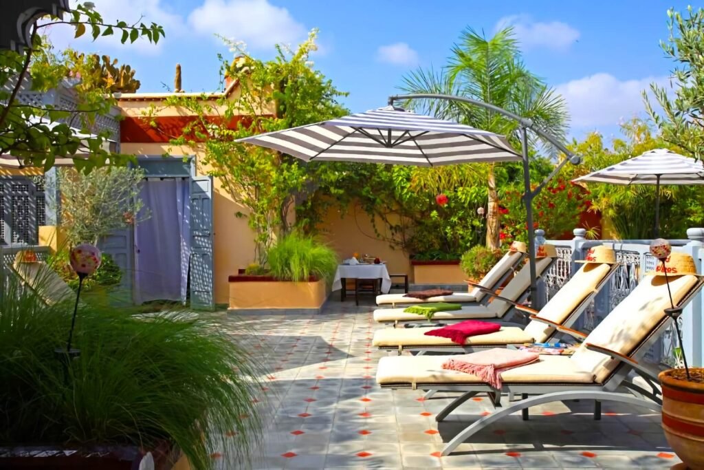 Relaxed rooftop seating area at Riad Noos Noos with colorful decor and Marrakech Medina atmosphere