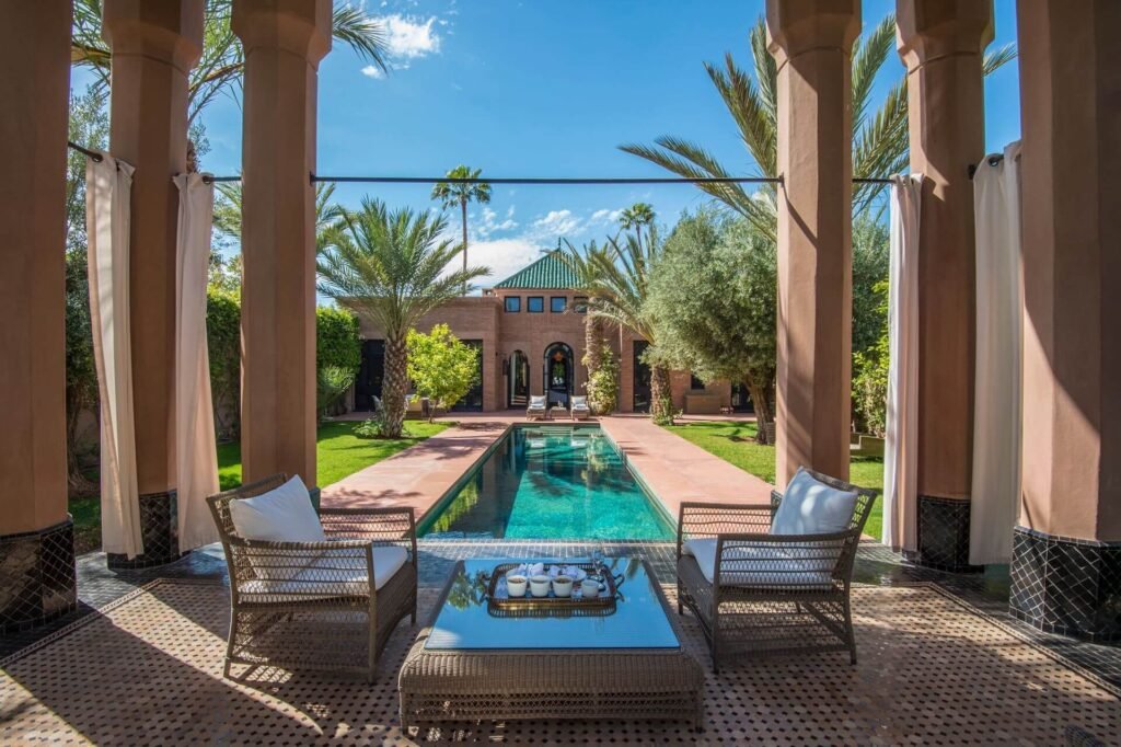 Terrace pool at Selman Marrakech with palm trees and elegant resort setting