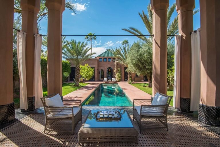 Terrace pool at Selman Marrakech with palm trees and elegant resort setting